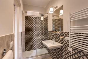 a bathroom with a sink and a shower at The Club Navona in Rome