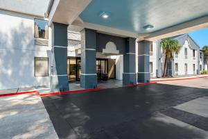 an empty driveway of a house with a building at Quality Inn & Suites Lafayette in Lafayette