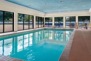 a swimming pool in a house with windows at Quality Inn & Suites Lafayette in Lafayette