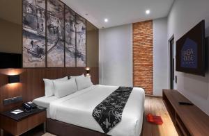 a hotel room with a bed and a tv at Baba House Melaka in Malacca