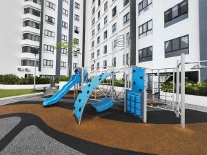 a playground with a slide in front of a building at Decozy 9 Ipoh Town Condo 12pax in Ipoh