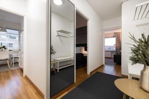 a large mirror in a living room with a table at Santa's Luxury City Apartment 3 in Rovaniemi