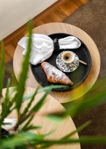 a table with a plate with food and a cup of coffee at Santa's Luxury City Apartment 3 in Rovaniemi +16 photos