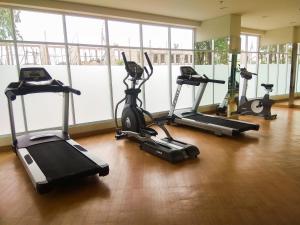 a gym with several exercise bikes in a room at Modern and Spacious Studio Apartment at Mustika Golf Residence By Travelio in Cikarang