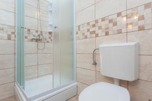 a bathroom with a toilet and a glass shower at Hedera Estate, Hedera A51 in Dubrovnik +27 photos