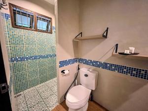 a bathroom with a toilet and a glass shower at Charming Getaway in Koh Chang in Ko Chang +29 photos