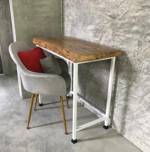 a wooden table with a chair and a desk with a red pillow at New Moon in Thong Sala +48 photos