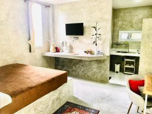a bedroom with a bed and a sink in a room at New Moon in Thong Sala