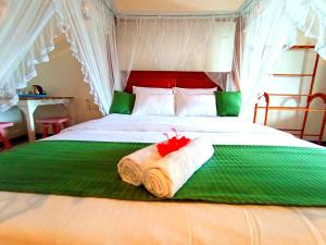 ein Schlafzimmer mit einem Bett und einem Handtuch darauf in der Unterkunft Lavender mirissa in Mirissa