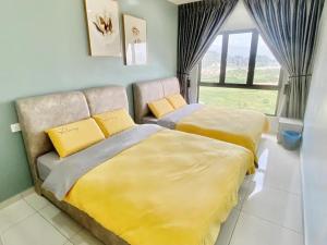 a bedroom with two beds with yellow and gray sheets at Decozy7.0 Ipoh Town Condo(12pax) in Ipoh +21 photos