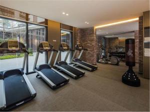 a gym with several cardio machines in a room at MiniMax Premier Hotel Shanghai Hongqiao in Shanghai