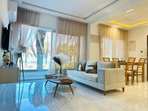 a living room with a couch and a table at BATUU Luxury Living SEA FRONT in Bizerte