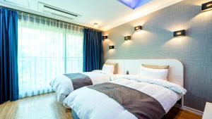 En eller flere senge i et værelse på Namwon Hanjeungwonstay Pension