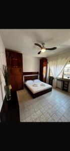 a bedroom with a bed and a ceiling fan at Home & Beach Il Duca in Lido di Ostia