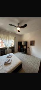 a bedroom with a bed and a ceiling fan at Home & Beach Il Duca in Lido di Ostia