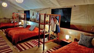 a bedroom with two bunk beds and a bedskirts at Mara Siria Tented Camp & Cottages in Aitong +35 photos