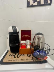 a counter top with a coffee maker and a box at Seventeen Home in Naples