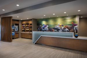 a store lobby with a painting of horses racing at SpringHill Suites by Marriott Bowling Green in Bowling Green +34 photos