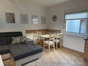 a living room with a couch and a table and chairs at NEU! Ferienhaus Sanja in Peickwitz