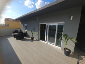 a balcony of a house with plants on it at Villa AS MOON with pool in Split