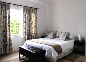 En eller flere senge i et værelse på Little Aloe Cottage