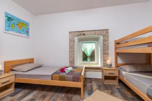a bedroom with two bunk beds and a window at House Edo in Svetvinčenat +19 photos