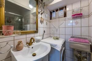 a bathroom with a sink and a mirror at House Ingrid in Rijeka +35 photos