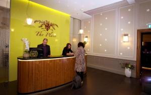 a woman standing at a bar in a restaurant at The Place Hotel in Edinburgh