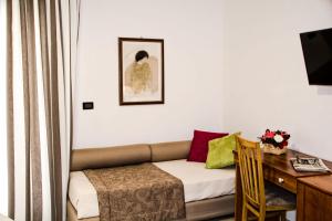 a living room with a couch and a desk at Hotel Sirenetta in Isola delle Femmine +70 photos