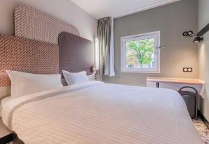 Postel nebo postele na pokoji v ubytování B&B HOTEL Mulhouse Dornach