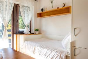 Un dormitorio pequeño con una cama y una ventana. en Apartma Planinski Raj, en Zreče