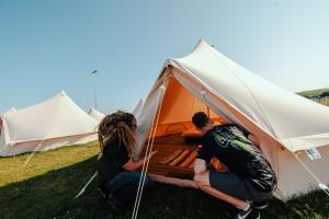 a group of three people in a tent at Duke Travel Official TT Glamping - Douglas in Kirk Braddon