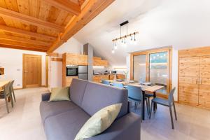 a living room with a blue couch and a table at Enjoy Alps - appartamenti vacanza in Sampeyre
