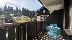 a balcony with a blue chair and a view at Grand Morillon 212 - 2P5 in Morillon +3 photos