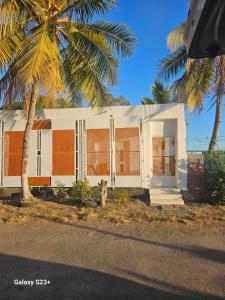 a house with a dog standing in front of it at LA KAZ by KAZ KAFE in Pamandzi