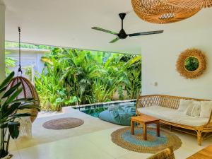 a living room with a couch and a pool at Marlaca Villas Lombok in Kuta Lombok
