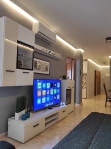 a living room with a flat screen tv sitting on a cabinet at Parque De Las Naciones Dragon con garaje ! in Torrevieja