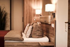 um quarto de hotel com uma cama com almofadas em Pension Carlbauer em Kelheim