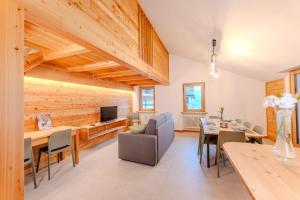 a dining room with wooden walls and a table and chairs at Enjoy Alps - appartamenti vacanza in Sampeyre