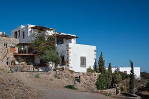 a house on the side of a hill at Sunset & Ocean view Villa in Patmos