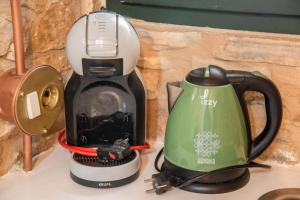 a coffee maker sitting on top of a counter at Almond Blossom Cottage 1 in Philotium