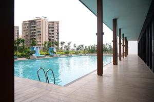 a swimming pool in the middle of a building at Club Charholi in Lohogaon