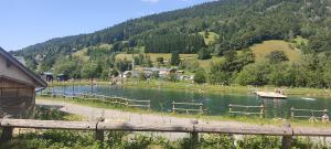 a river with a wooden fence next to a mountain at Studio Appartement Grand Serre in La Morte +8 photos