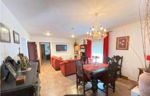 a living room with a red couch and a table at Villa La Luna CHALET COMPLETO in Guadajira