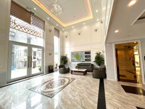 a living room with a lobby with a couch and chairs at Cannon Fort - The Viewpoint Hotel in Cat Ba