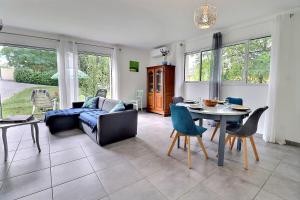 a living room with a couch and a table and chairs at Maison chaleureuse Sud Ardèche in Pradons