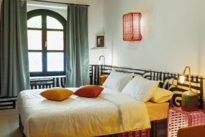 a bedroom with a bed with two pillows on it at taman'art space in Aït Benhaddou +62 photos