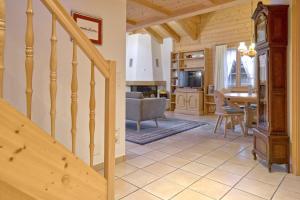 a staircase leading to a living room and a kitchen at Apartment St. Louis 3.5 - GriwaRent AG in Grindelwald +9 photos