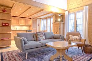 a living room with a couch and a table at Apartment St. Louis 3.5 - GriwaRent AG in Grindelwald