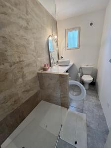 a bathroom with a sink and a toilet at Superbe maison avec piscine in Monticello +14 photos